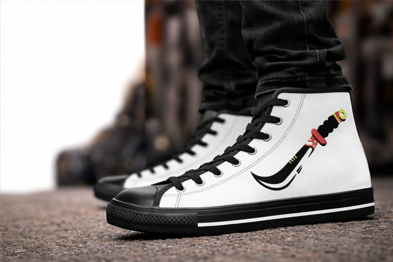 White high-top sneakers with black accents and a unique design on a blurred background